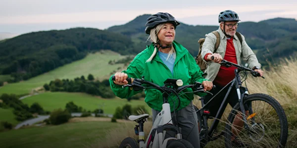 a couple riding bikes in the foothills
